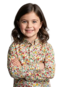 Little girl smiling in floral shirt at camera